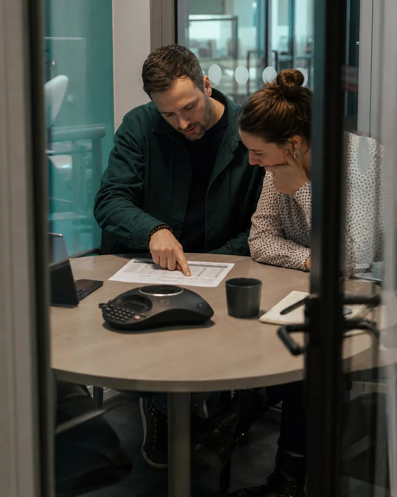 B2B marketing and sales leads reviewing a pipeline printout